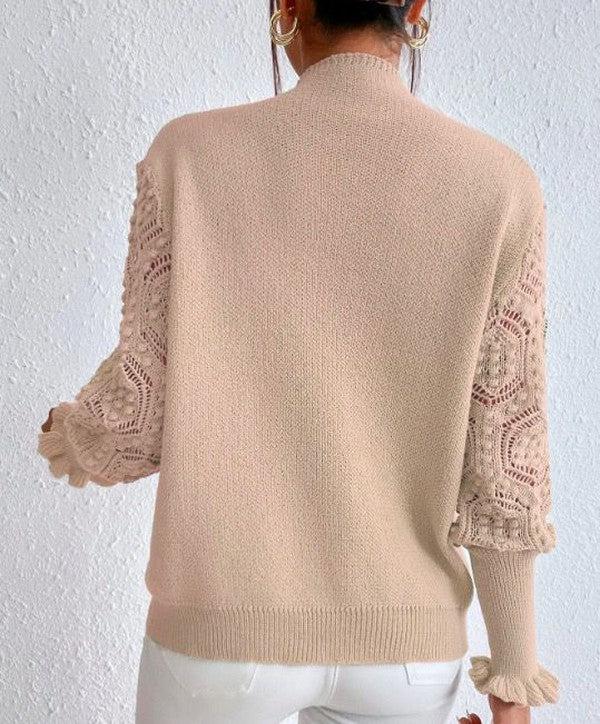 Pull abricot clair avec manches longues et motifs spectaculaires